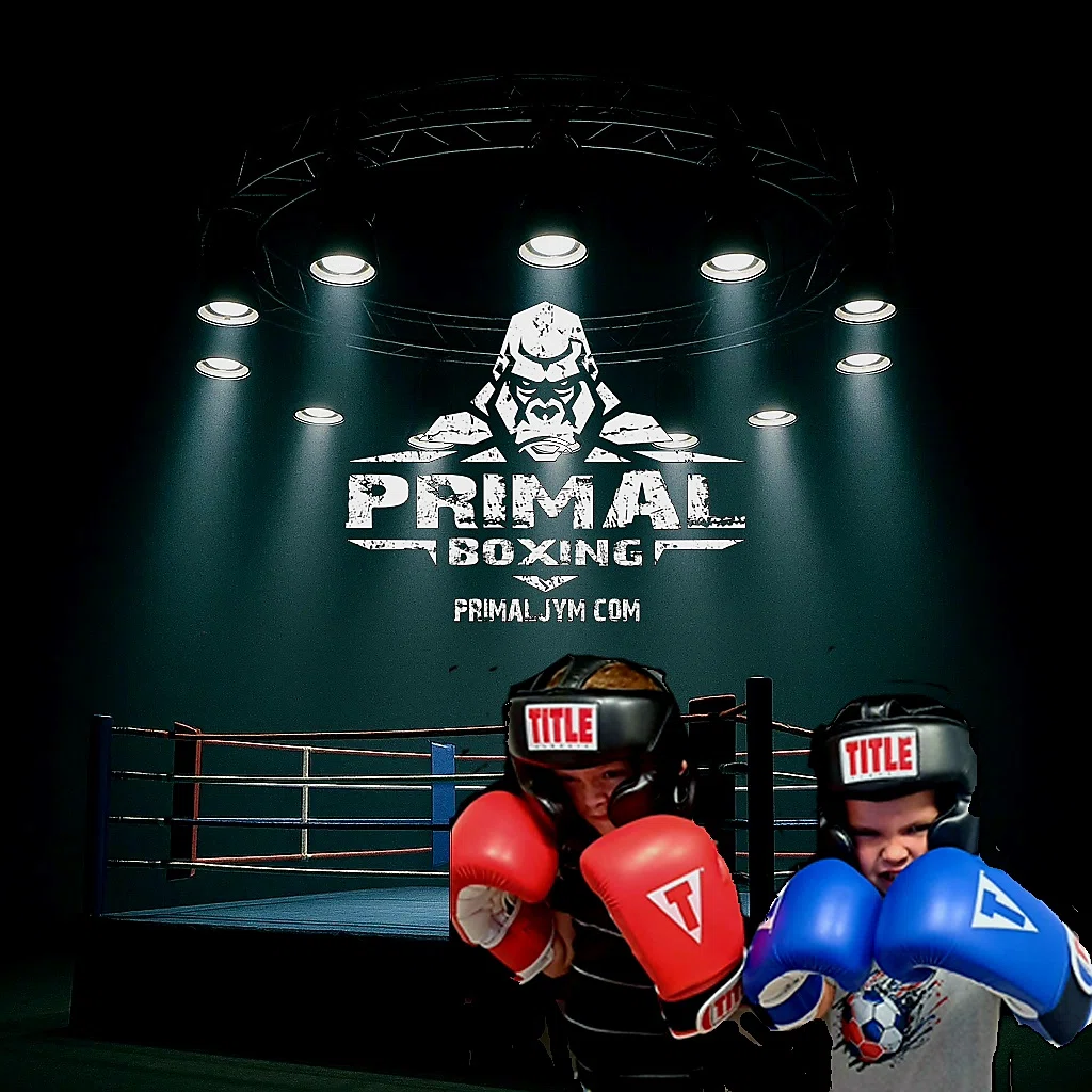Youth boxers in gloves posing in front of the ring at Primal Boxing