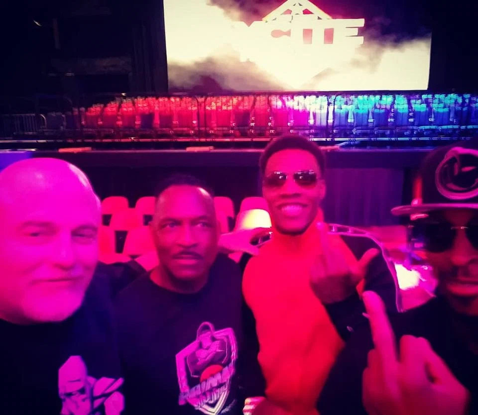 Primal championship group photo backstage under pink lights