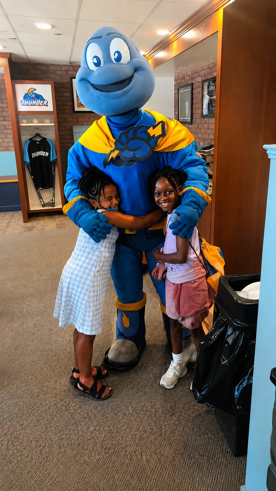 Primal family kids enjoying a community event with a mascot