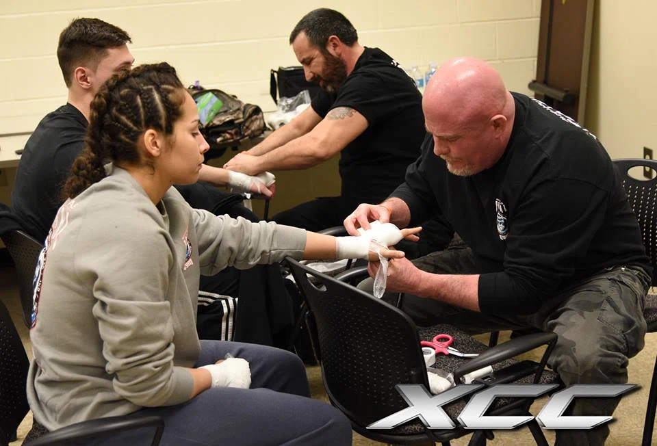 Coach preparing a fighter backstage before competition