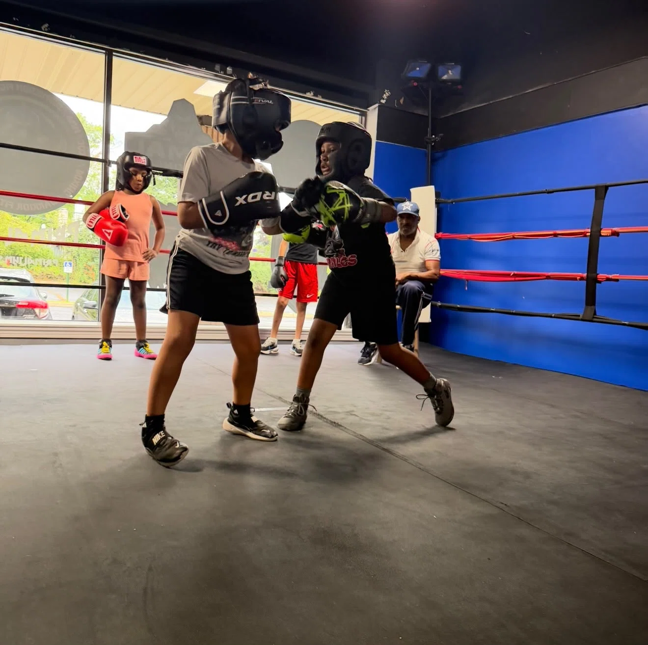 Youth boxing sparring and coaching session inside the ring at Primal Jym